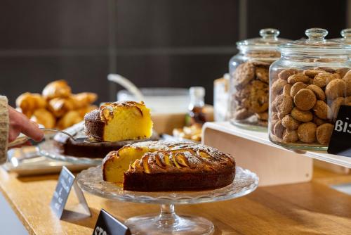 a table with cakes and other pastries on a table at La Villa - Luxury Guest House in Trento