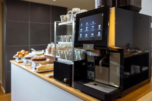 a coffee machine sitting on top of a counter at La Villa - Luxury Guest House in Trento