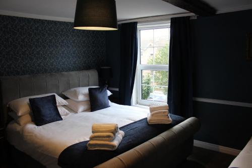 a bedroom with a bed with towels on it at Beautiful 7 Bedroom House With Hot Tub Sleeps 14 in Great Ouseburn