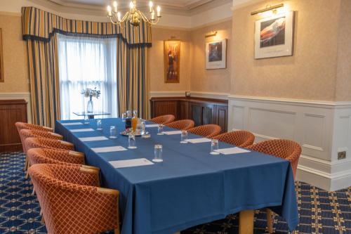 a conference room with a blue table and chairs at B/W Plus Buxton Lee Wood Hotel in Buxton