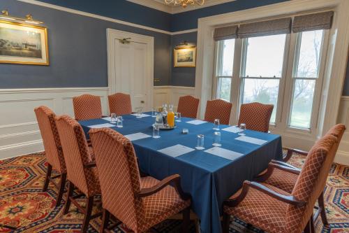 a conference room with a blue table and chairs at B/W Plus Buxton Lee Wood Hotel in Buxton