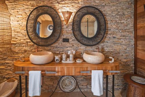 two sinks in a bathroom with two mirrors at Pearl Mara in Masai Mara