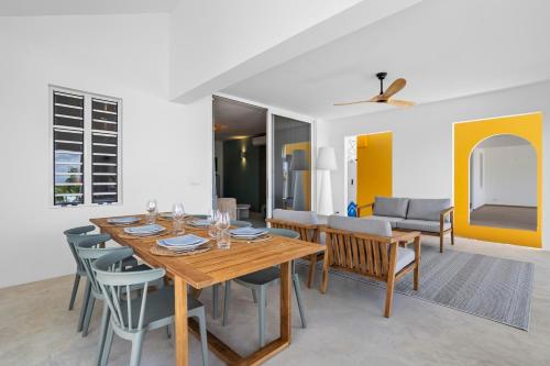 a dining room with a wooden table and chairs at Casa Blue Marlin in Kralendijk
