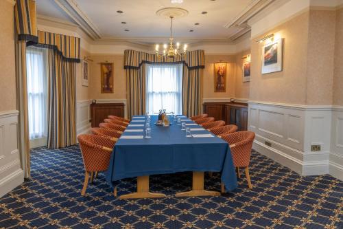 a conference room with a blue table and chairs at B/W Plus Buxton Lee Wood Hotel in Buxton