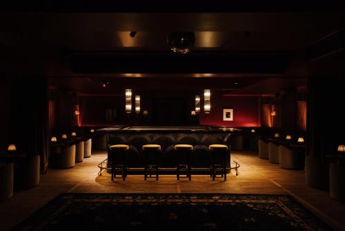 a group of chairs in a room with a stage at Hotel Rochechouart - Orso Hotels in Paris