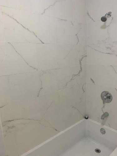 a bathroom with a shower with white marble walls at Only Private Room Steps To University Of Ottawa Downtown Not Full apt in Ottawa