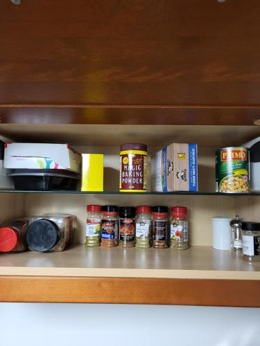 a pantry shelf with lots of food items on it at Cozy Suite with HOT TUB & Highspeed Internet in Grimsby