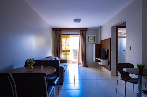 a living room with a couch and a table at Boulevard Suíte Hotel by WAM Experience in Caldas Novas