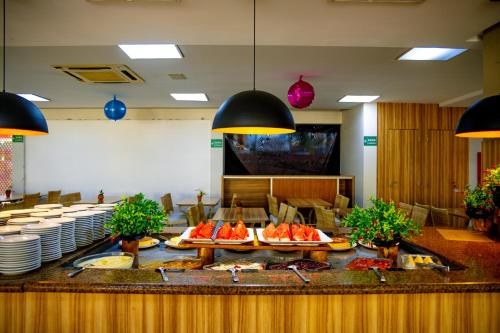a buffet in a restaurant with plates of food at Boulevard Suíte Hotel by WAM Experience in Caldas Novas
