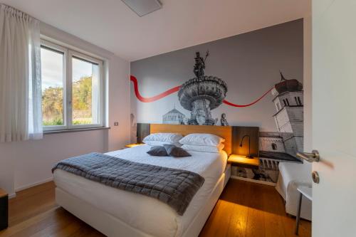 a bedroom with a large bed with a red ribbon on the wall at La Villa - Luxury Guest House in Trento