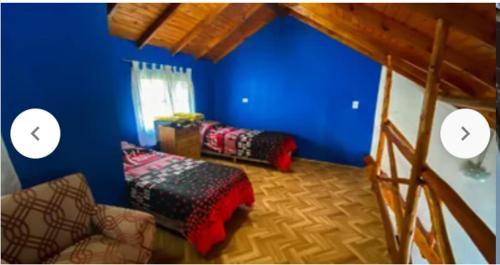 a room with blue walls and a couch and a bed at Duplex Brisas del Mar 2A in Barrio Félix U Camet
