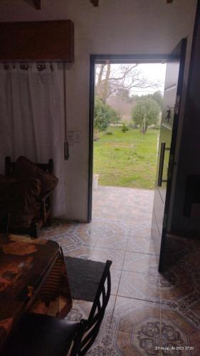 a living room with a door open to a yard at Duplex Brisas del Mar 2A in Barrio Félix U Camet