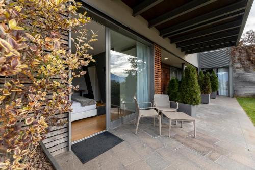 an internal courtyard of a house with a table and chairs at La Villa - Luxury Guest House in Trento