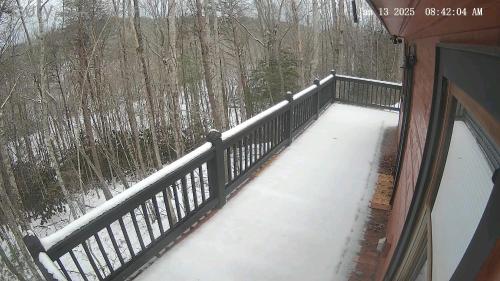 a balcony with snow on the floor of a house at Perfectly Imperfect Cabin in Turtletown