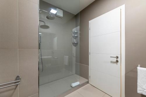 a shower with a glass door in a bathroom at La Villa - Luxury Guest House in Trento