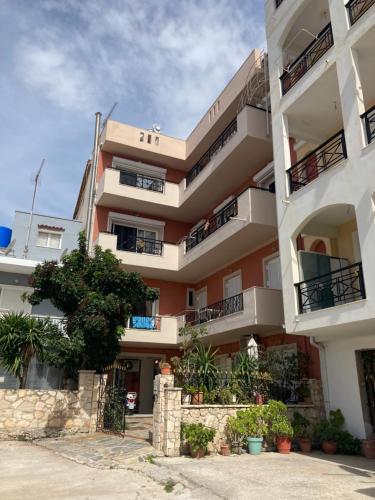 a large apartment building with balconies and plants at Arty Loft with Sea & City Views in Zakynthos Town