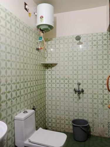 a bathroom with a white toilet and a sink at Holiday home stay Puducherry in Puducherry