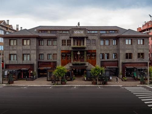 a large building on a city street with a street at Mater Hotel in Canela
