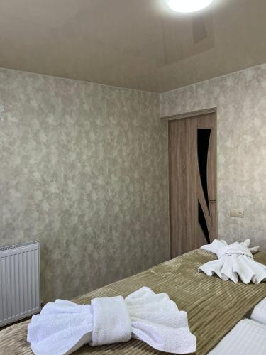 a bedroom with two white towels on a bed at Garden house in Akhaltsikhe