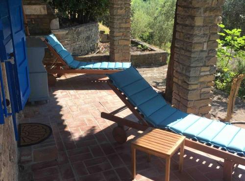 a pair of blue lounge chairs on a patio at Villa Bella in Grožnjan