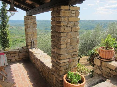 a stone wall with two potted plants on a patio at Villa Bella in Grožnjan