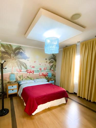 a bedroom with a large bed with a red blanket at Las Moras Multiespacio in Cucha Cucha