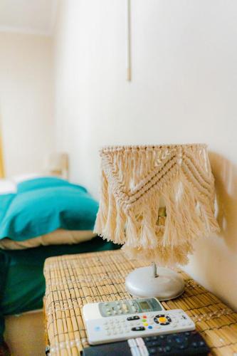 a table with a remote control on top of a bed at Las Moras Multiespacio in Cucha Cucha
