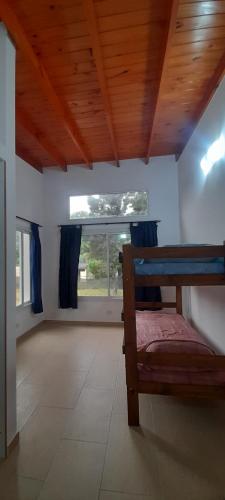 a bedroom with a bed and a large window at los QUISPER in San Bernardo