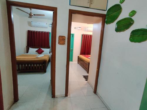 a room with a bedroom with a bed and a mirror at Holiday home stay Puducherry in Puducherry