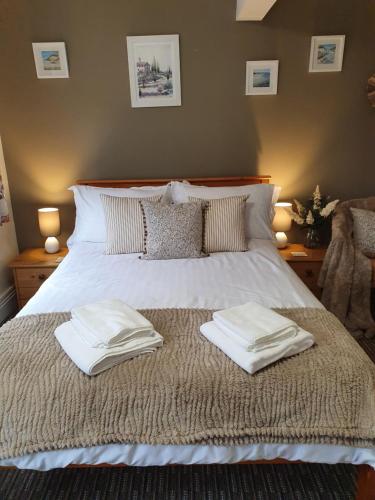 a bed with two towels on top of it at Apple Blossom Guesthouse in Rempstone