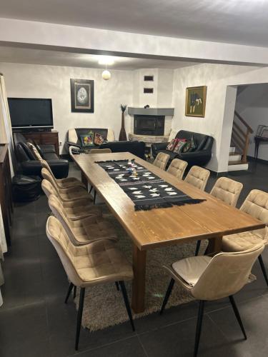 a living room with a large wooden table and chairs at Cabana Sweetlife in Rimetea