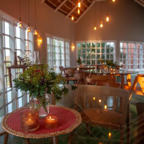 a dining room with a table with candles and chairs at Humbi Farm in Xai-Xai