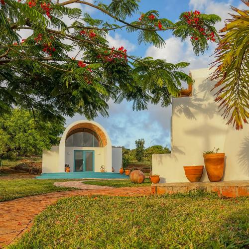 a house in the middle of a yard at Humbi Farm in Xai-Xai