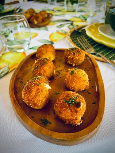 a wooden plate with some food on a table at Humbi Farm in Xai-Xai