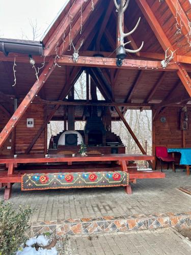 a large wooden pavilion with a picnic table in it at Cabana Sweetlife in Rimetea
