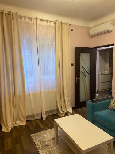 a living room with a couch and a table at House with 2 bedrooms in Bucharest