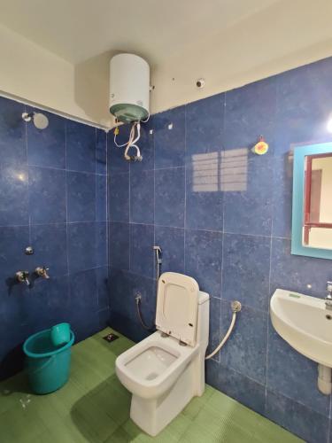 a bathroom with a toilet and a sink at Holiday home stay Puducherry in Puducherry