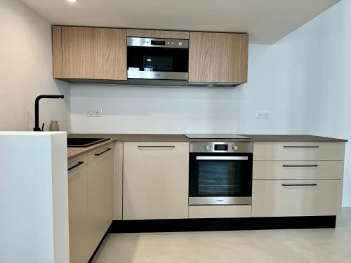 a kitchen with a stove and a microwave at Studio du port - Porte marine in Antibes
