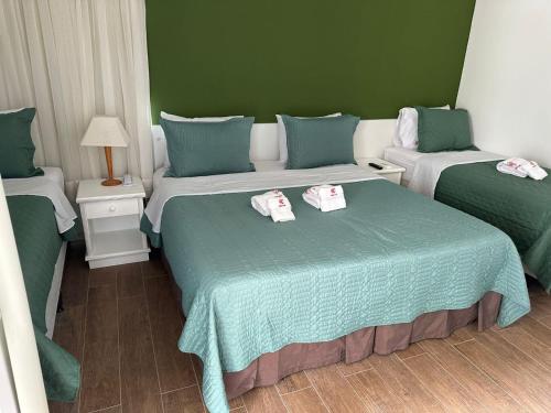 a room with two beds with towels on them at Recife Mar Flats Hotel in Recife