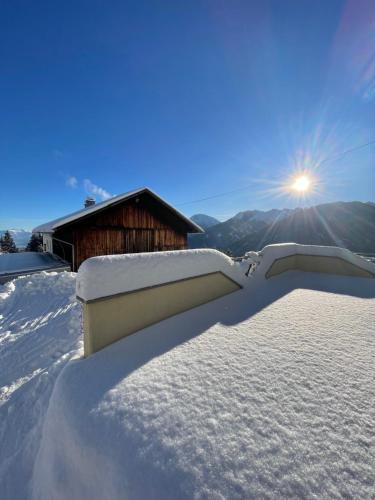 a pile of snow in front of a building at Koflers Ferienwohnungen in Oberperfuss