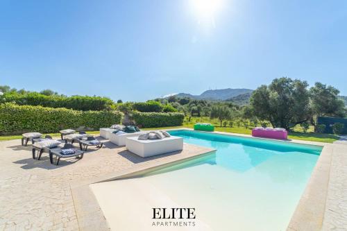 a villa with a swimming pool with furniture and a view at Lussuosa Villa con piscina a Porto Rotondo in Cugnana