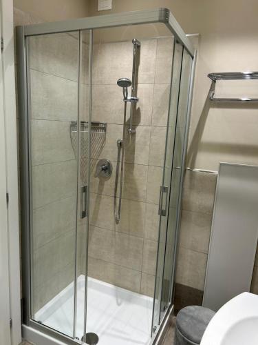 a shower with a glass door in a bathroom at Punta Faro in Lignano Sabbiadoro