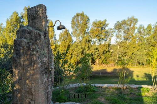 a stone post with a light on top of it at Lussuosa Villa con piscina a Porto Rotondo in Cugnana
