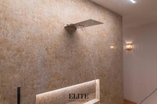 a bathroom with a water fountain on the wall at Lussuosa Villa con piscina a Porto Rotondo in Cugnana