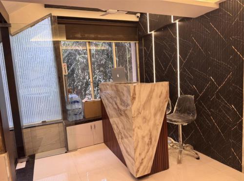 a room with a desk with a laptop on top of it at Hotel West Line Andheri in Mumbai