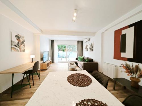 a living room with a table and a couch at Kalipsous by Verde Apartments in Athens
