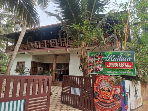a restaurant with a sign in front of a building at Kailasahomestay & Ayurvedic Spa in Pūvār