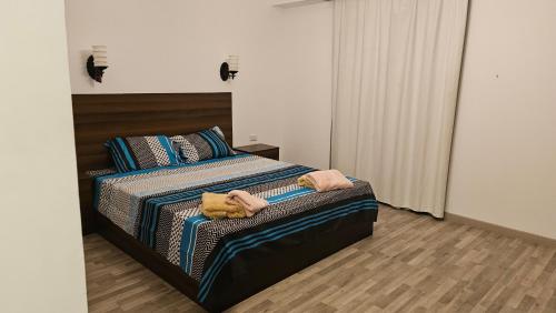 a bedroom with a bed with two towels on it at Apartman Al Dora Resindence in Hurghada
