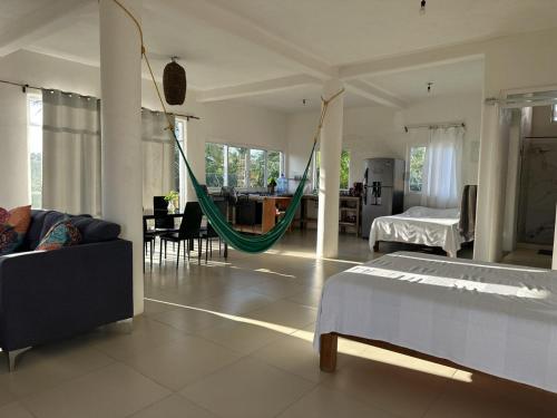 a living room with a hammock in a room at Zona Surf - Steps to the beach in Punta Mita
