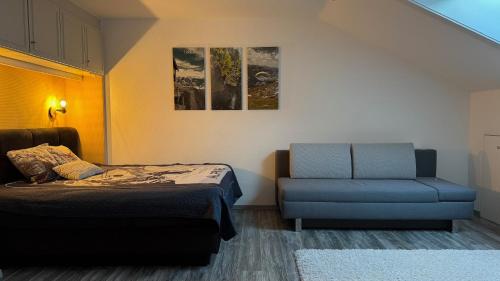 a bedroom with a bed and a blue chair at Ferienwohnung Alpenglück mit Schwimmbad und Sauna in Oberstdorf